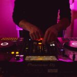 Person in Black Long Sleeve Shirt Playing Dj Controller